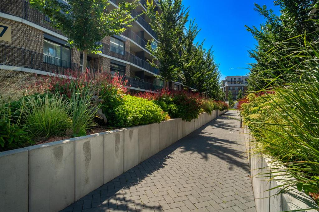 a sidewalk in front of a building with plants at Modern beautiful apartment close to the center in Bratislava