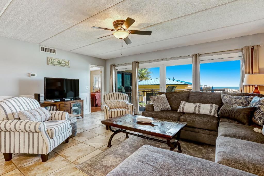 a living room with a couch and a table at Steps to Oceanside Condo in Amelia Island