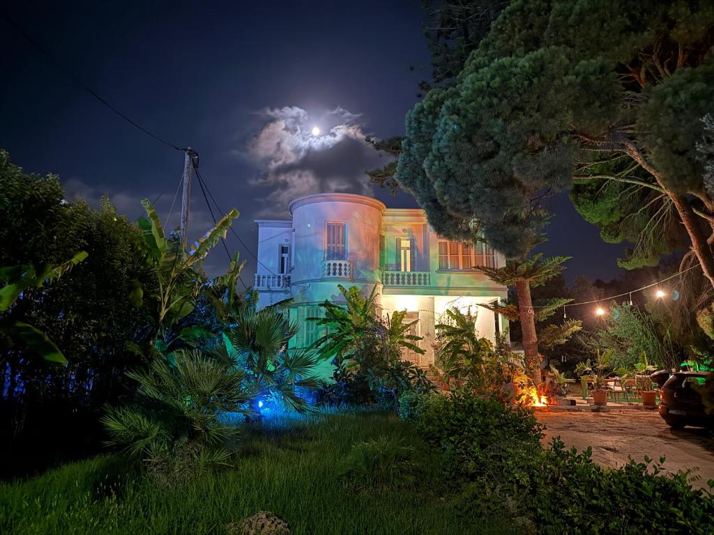 a house lit up at night with a lightning bolt at Tower Traditional Pool Villa in Kremasti