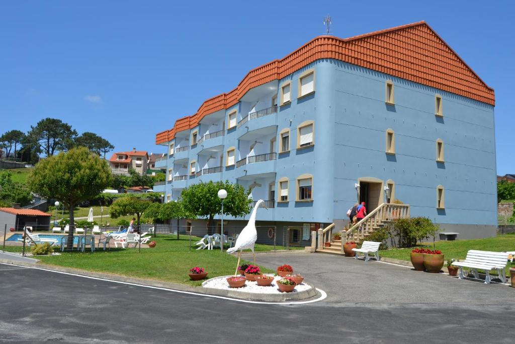 a large building with a statue in front of it at Apartamentos Montalvo Playa in Montalvo