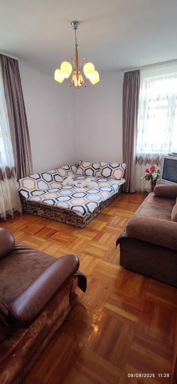 a living room with a bed in the middle of a room at 2 rooms Condo near Zoom Beach in Constanţa