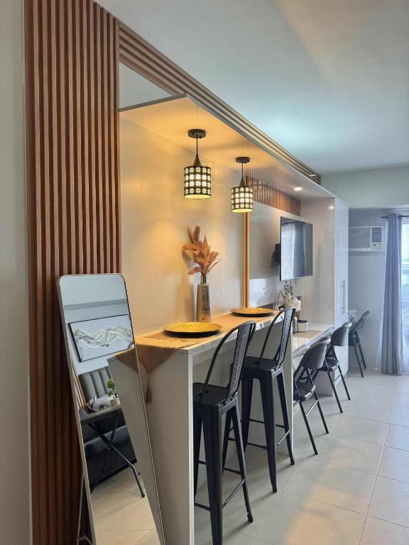 a kitchen and dining room with a table and chairs at Louritto Studio Type Condo at Avida Towers Riala Tower 3 in Cebu City
