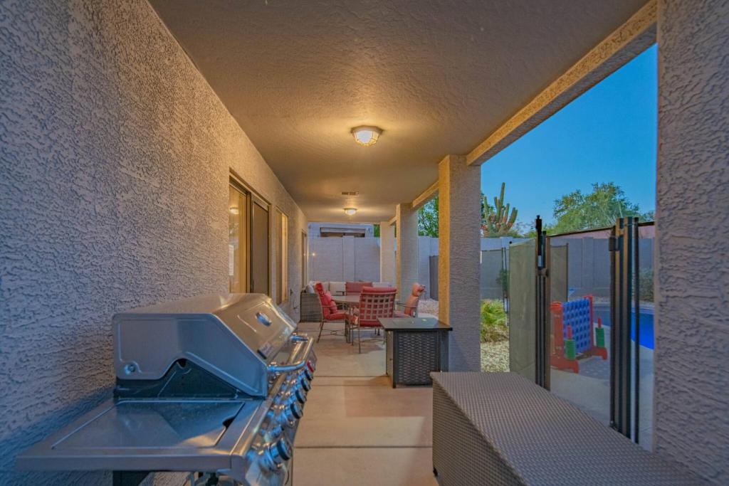 a kitchen with a grill on a patio at NEW Desert Daze, near Golf, Heated Pool+Spa, 12ppl in Scottsdale