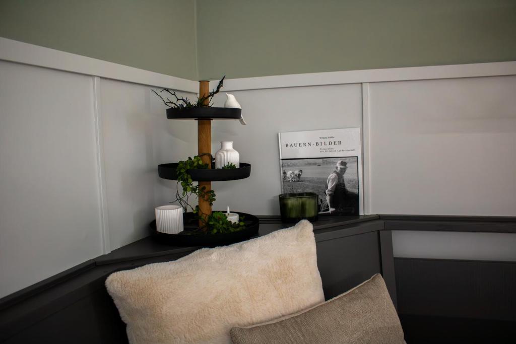 a living room with a chair and a shelf at Ferienhaus Hallmanns Hof in Schmallenberg