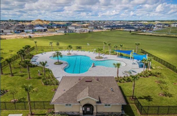 an aerial view of a swimming pool at a resort at Modern Lux 3BR Home Near Disney and Lego Land! in Haines City