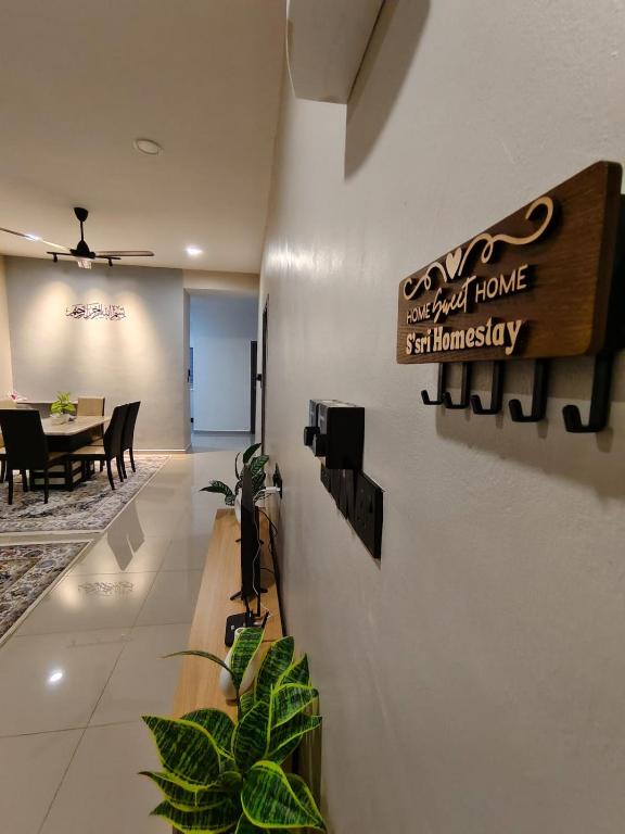 a dining room with a sign that reads next best home maintenance at Ssri Homestay Temerloh in Temerloh