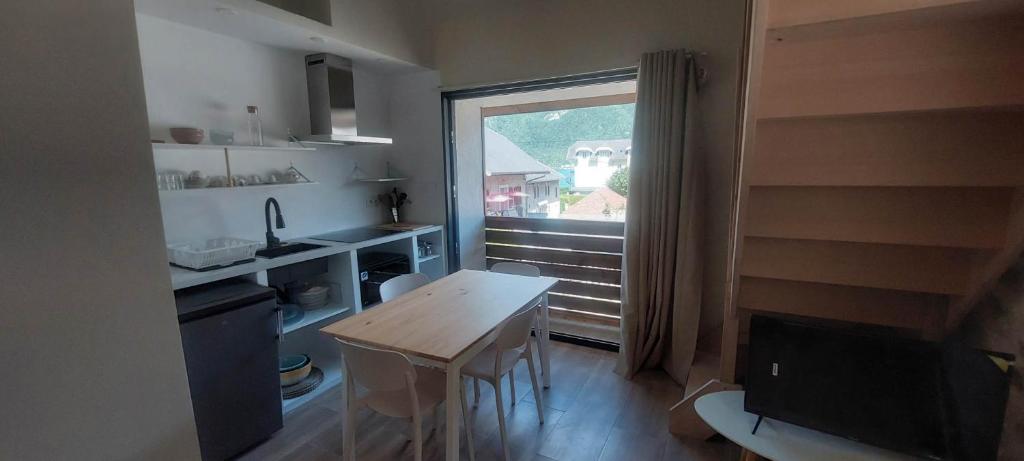 ドゥサールにあるAppartement 4 personnes avec mezzanine 100 metres du lacの小さなキッチン(テーブル付)、窓