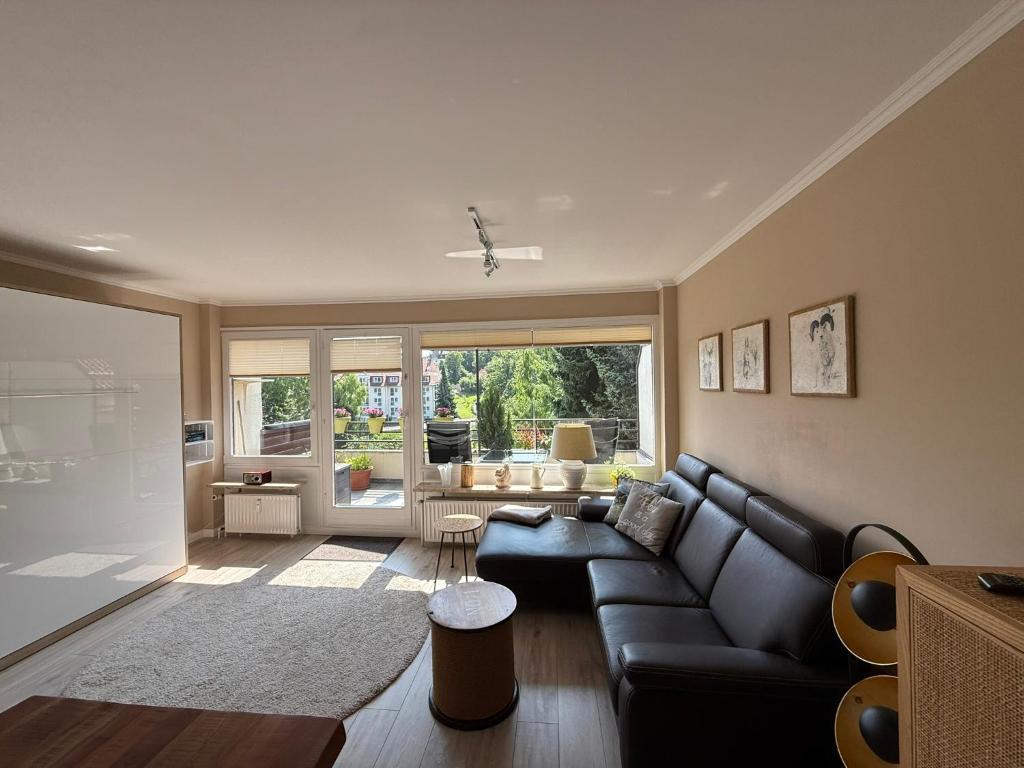 a living room with a couch and a table at Ferienwohnung Harzwiese in Bad Sachsa