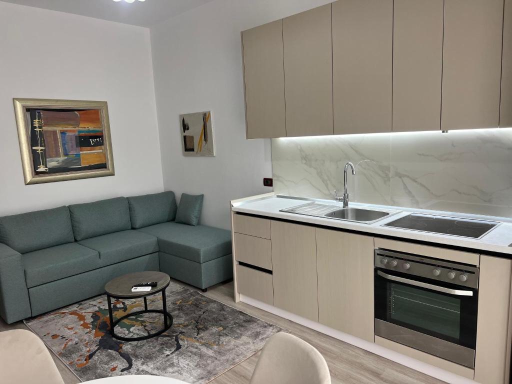 a kitchen with a couch and a sink at Rei's Apartment 2 in Tirana