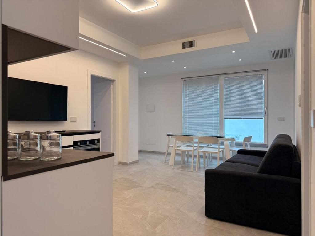 a living room with a couch and a table at Residenza Milla in Alassio