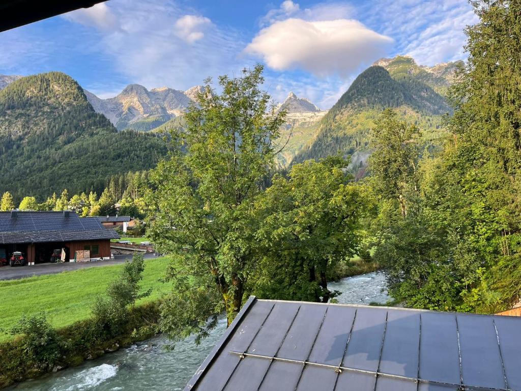 a solar panel next to a river with mountains at Steinhäusl in Lofer