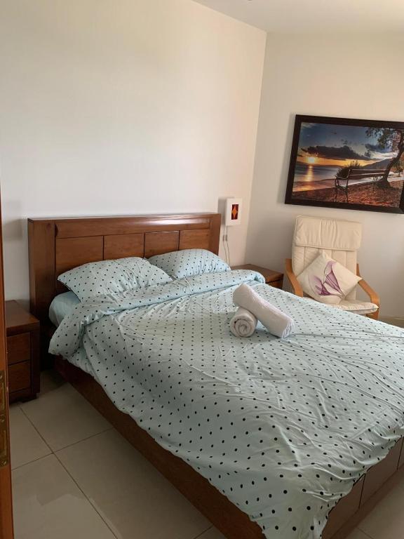 a bedroom with a bed with a stuffed animal on it at נופש במגדלי המלכים in Tiberias
