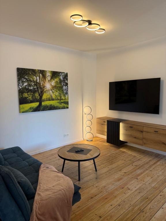 a living room with a couch and a flat screen tv at Ferienwohnung Hildegard in Clausen