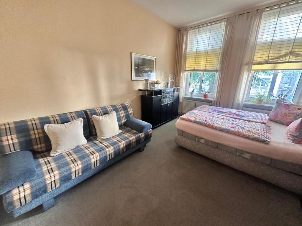 a living room with a couch and a bed at Ferienwohnung Warnemünde in Rostock