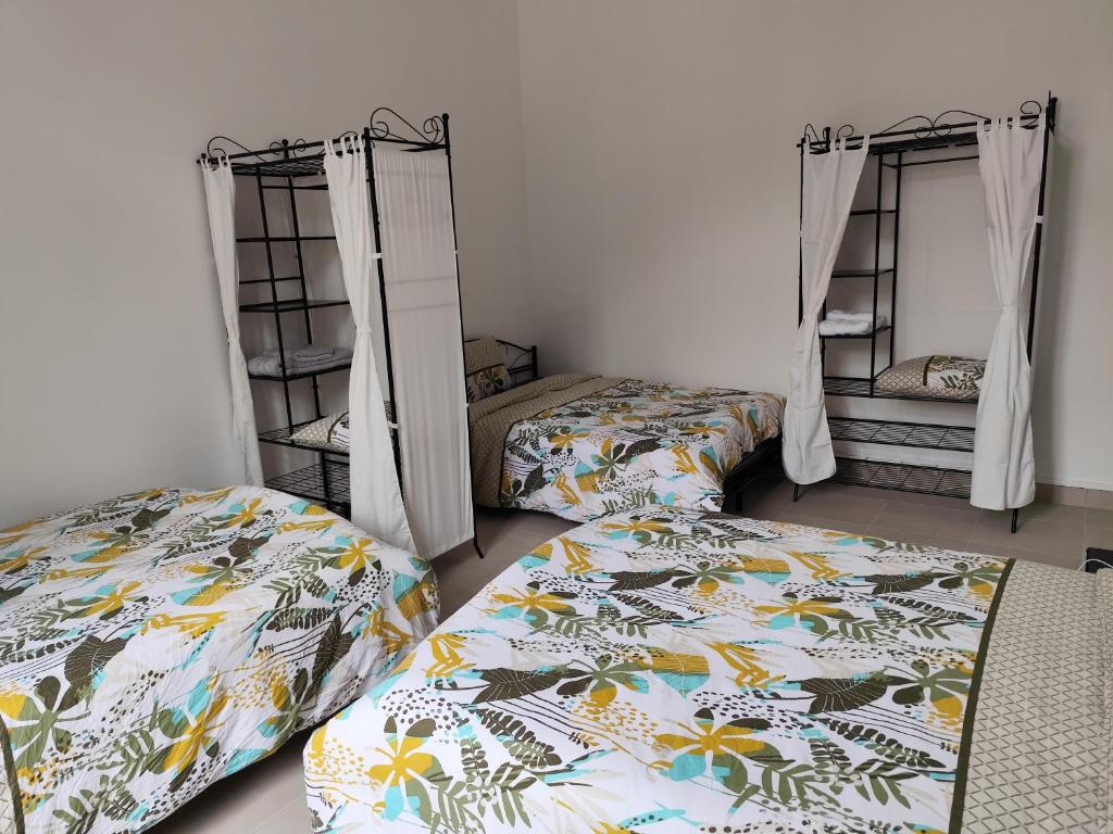 a bedroom with two beds and two bunk beds at O'Couvent - Appartement 131 - 2 chambres - 90 m2 - Troisième étage in Salins-les-Bains