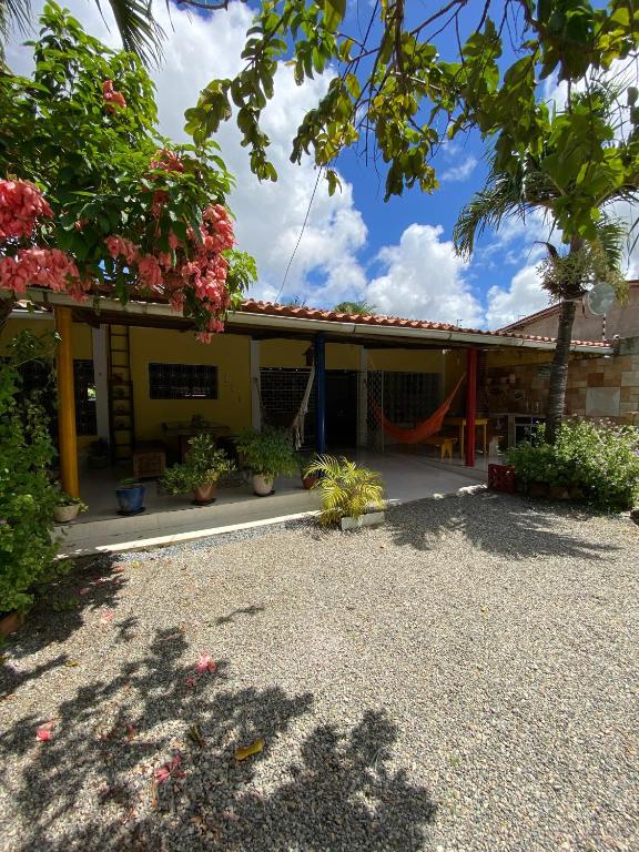 a house with a playground in front of it at Refúgio do Tio em Jacumã in Conde