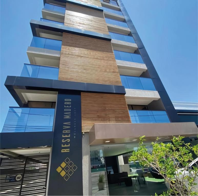 a building with a sign on the side of it at Reserva Madero 201 Vista Mar in Natal