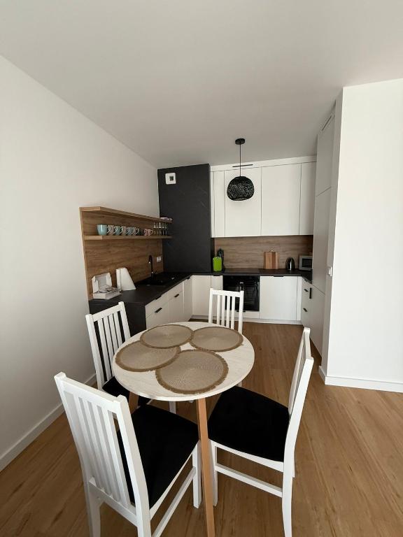 a kitchen with a table and chairs in a room at Corale in Łagów