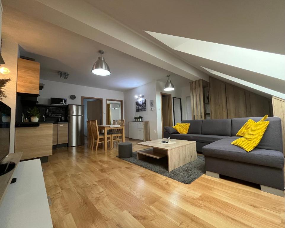 a living room with a couch and a table at Apartment Loft Fifteen in Dunajská Streda