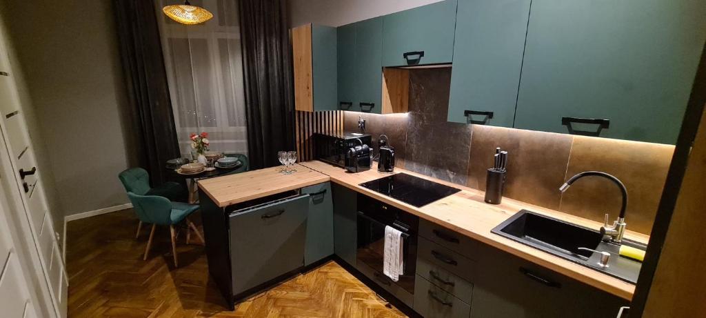 a kitchen with a counter with two sinks and a table at Lucia in Jarosław
