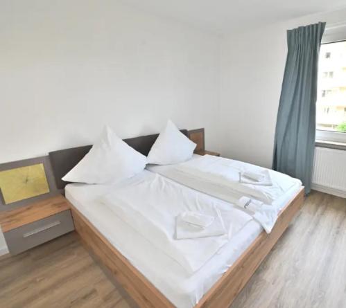 a bedroom with a bed with white sheets and a window at Rooms ETVY, Tv AC in Ulcinj