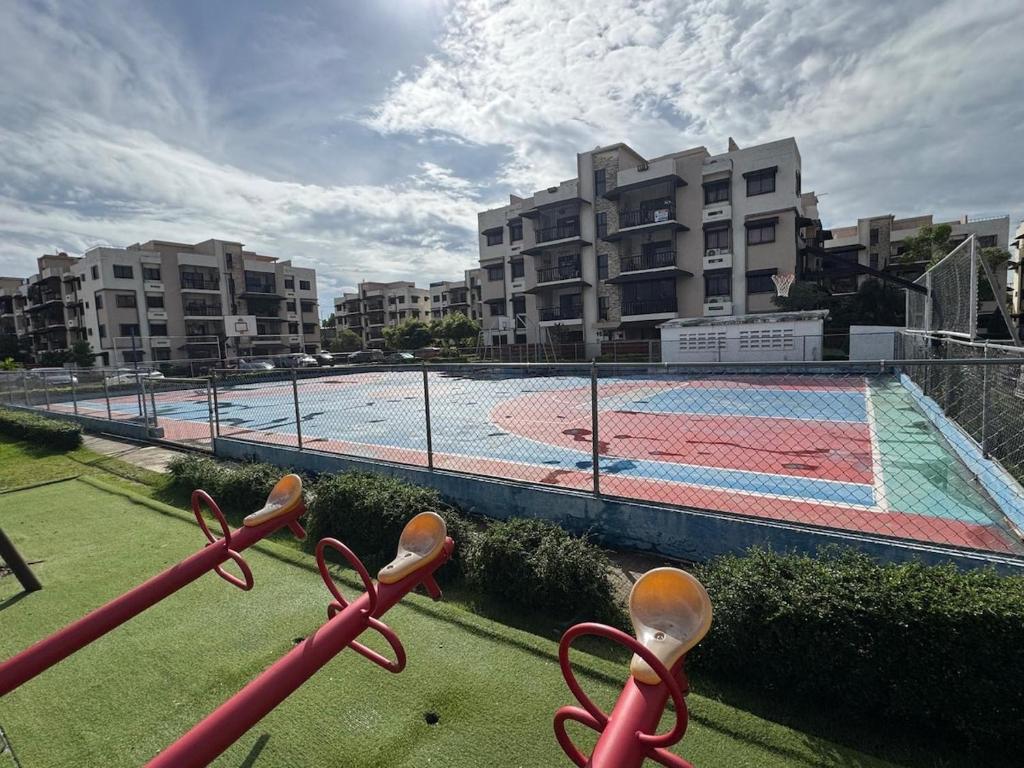 a view of a swimming pool with a tennis court at Luxurious and comfortable 1 level in Ensanche Savica de Mendoza