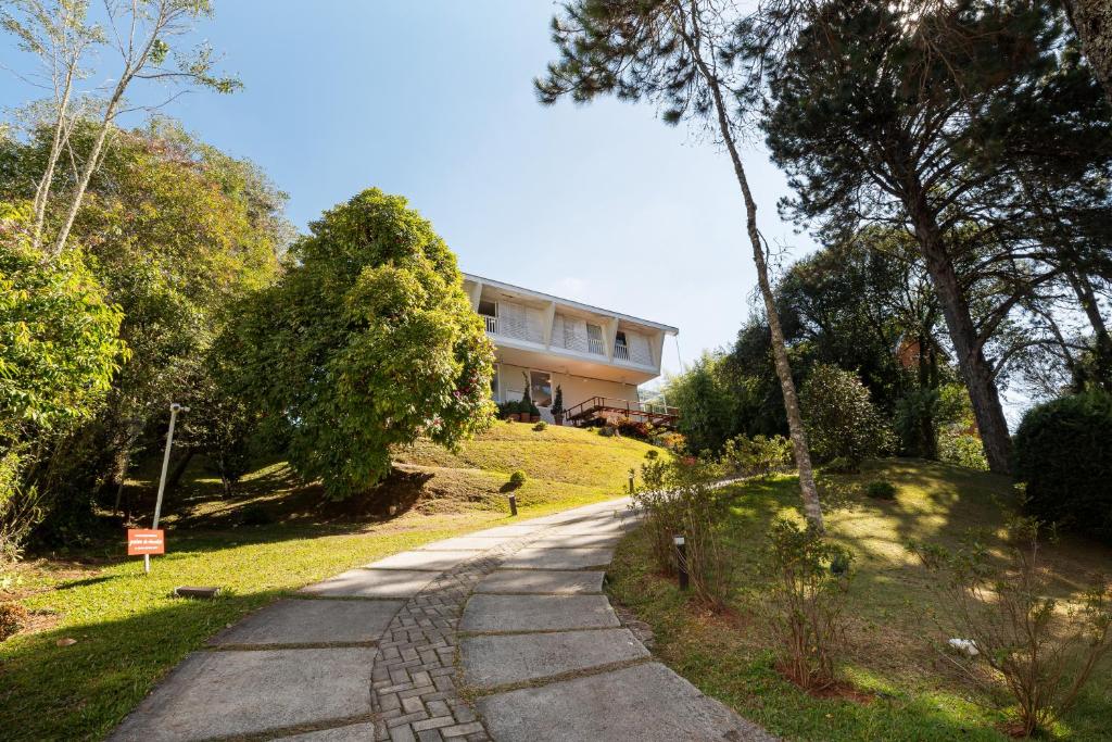 a house on a hill next to a road at Villa du Chocolat in Campos do Jordão