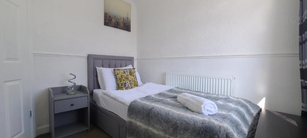 a small bedroom with a bed and a night stand at Starlet Single Room in Manchester