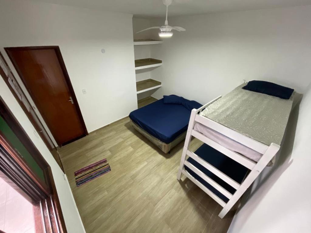 a small room with two bunk beds in it at Pousada Villa Beach Praia Grande in Praia Grande