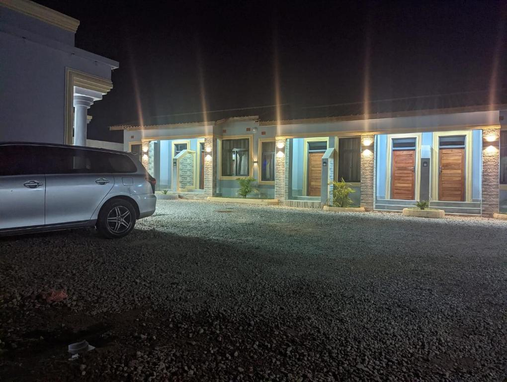 a car parked in front of a house at night at Chomz View Lodges in Lusaka