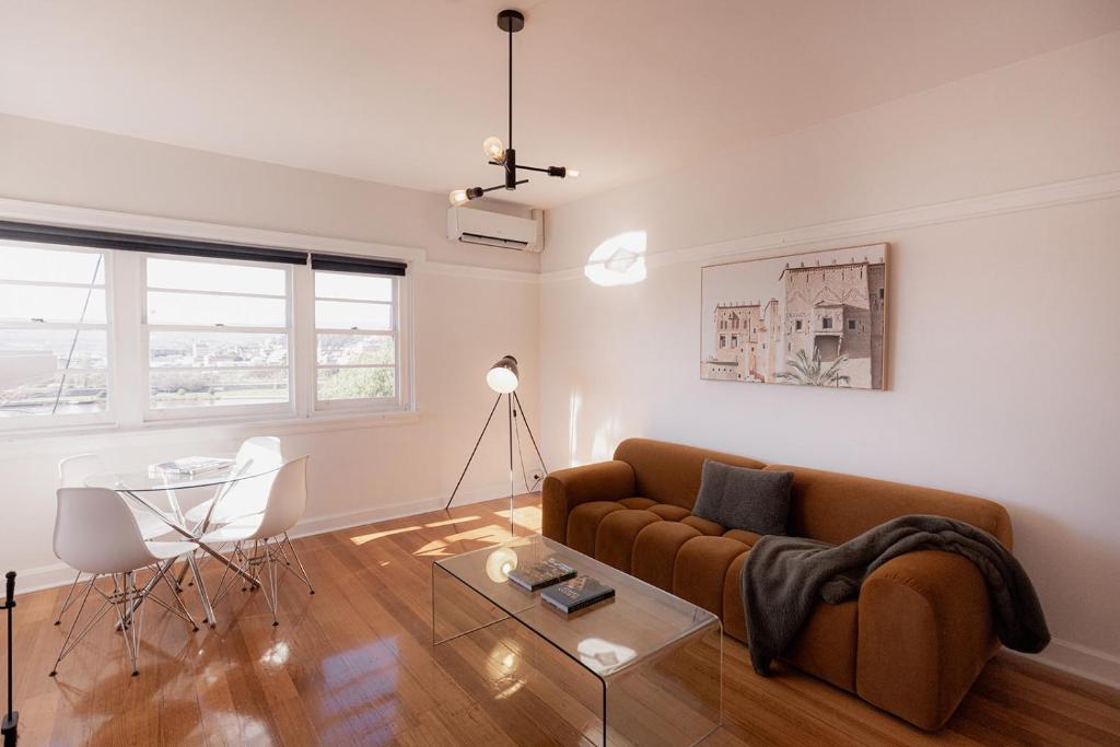 a living room with a couch and a table at Trevallyn Retreat with River Views in Royal Park