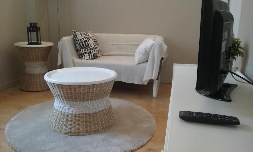 a living room with a couch and a television at Residences De Chartres in Chartres