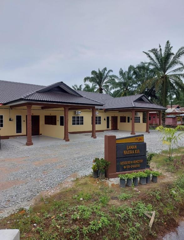 a building with a sign in front of it at Laman Nazira Kia in Kampong Ijok