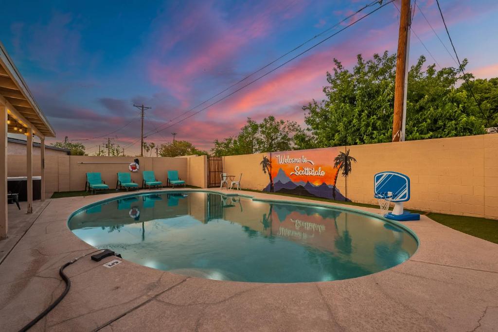 a small swimming pool with chairs in a backyard at Scottsdale 4 Bedroom Vacation Home with Pool, Hot Tub, and Mini Golf Near Old Town Entertainment and Dining! Great for Families! Near Airport in Scottsdale