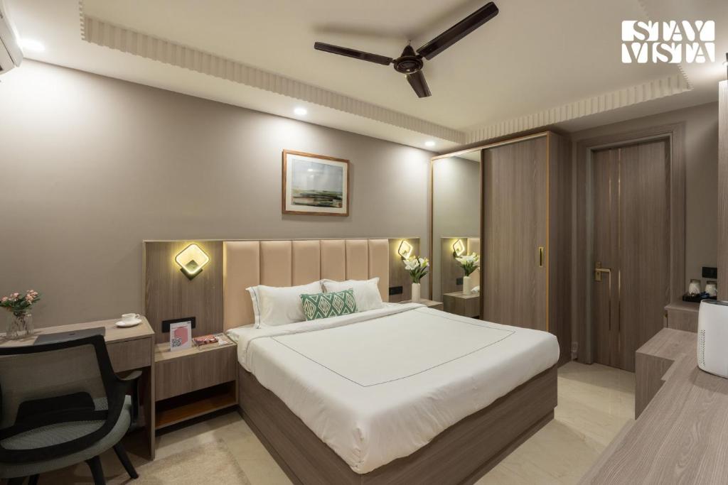 a bedroom with a bed and a desk and a bed sidx sidx sidx at StayVista Residences near Cyber City Hub with Gym & Air Purifier in Gurgaon