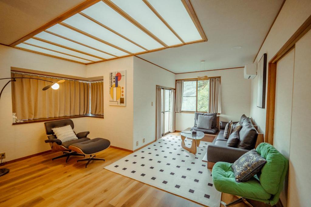 a living room with a couch and chairs and a skylight at 熱海 相の原 in Atami