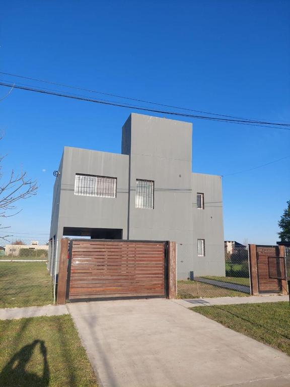 a white building with a wooden gate in front of it at Paz en Funes in Funes
