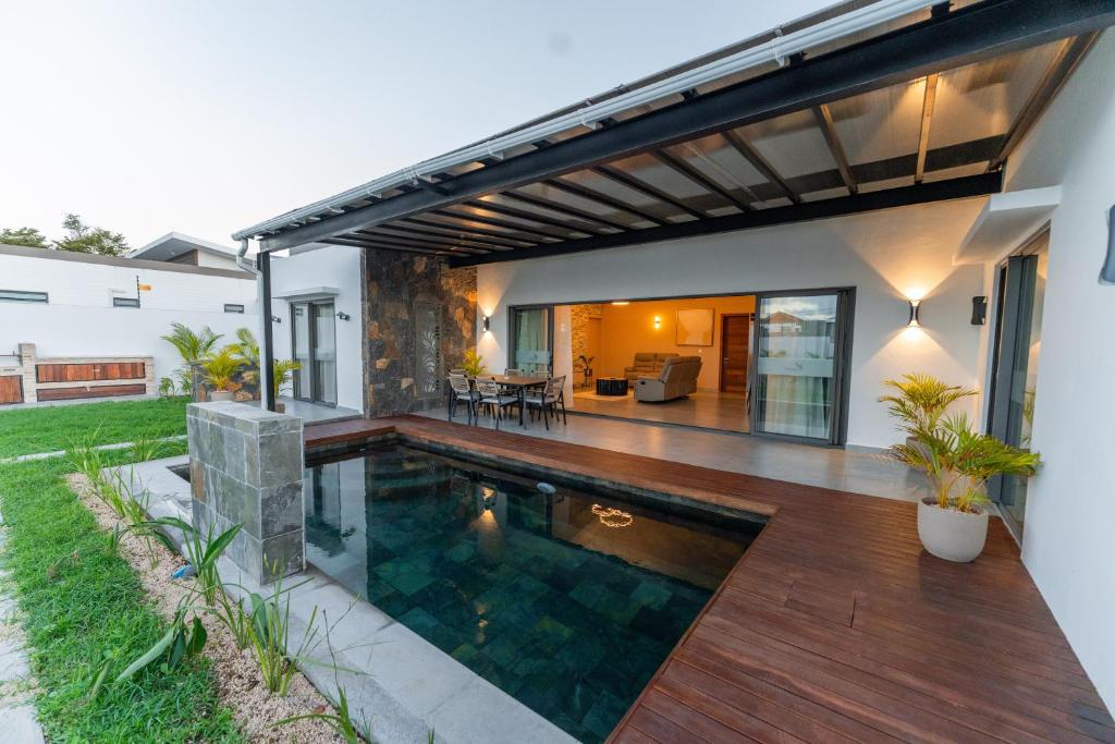 a swimming pool in the backyard of a house at Nilaya Villa by Swarga Mauritius in Cap Malheureux