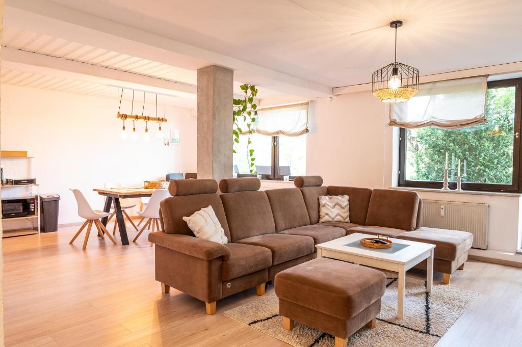 a living room with a couch and a table at Ferienwohnung Alpenglück in Seeg