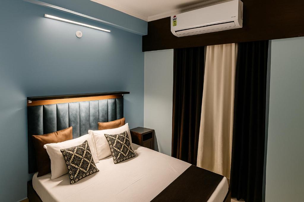 a bedroom with a bed and a air conditioner at VVIP Address Homestay Jagatpura Jaipur Luxury Stay in Jaipur