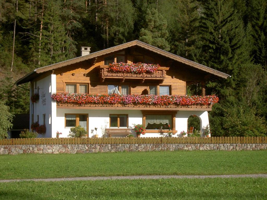 une maison avec des fleurs au sommet dans l'établissement Landhaus Schmitte, à Biberwier