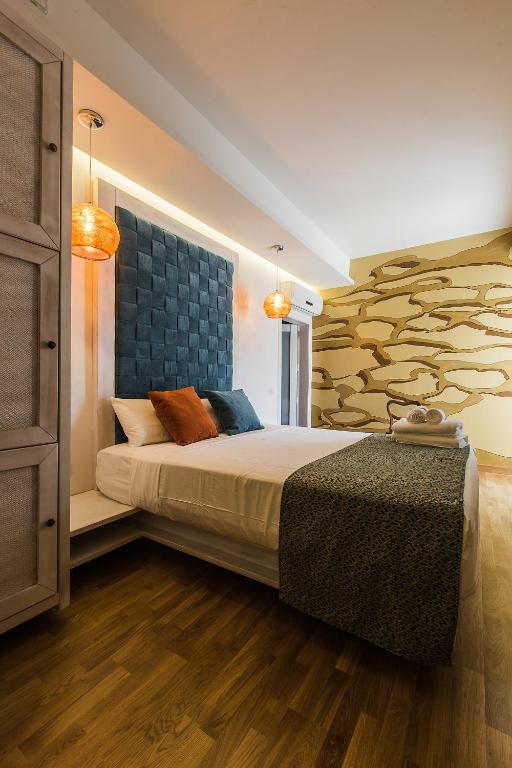 a bedroom with a bed and a wall with a tree mural at Murella Living in Marsalforn