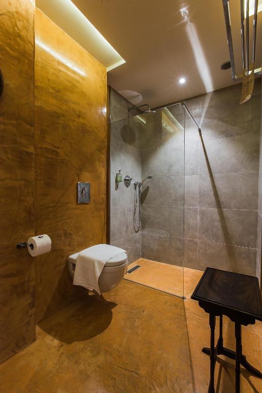 a bathroom with a shower and a toilet and a sink at Murella Living in Marsalforn