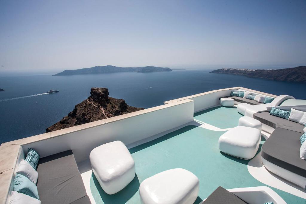 a boat with chairs and a view of the water at Andronikos Santorini in Imerovigli