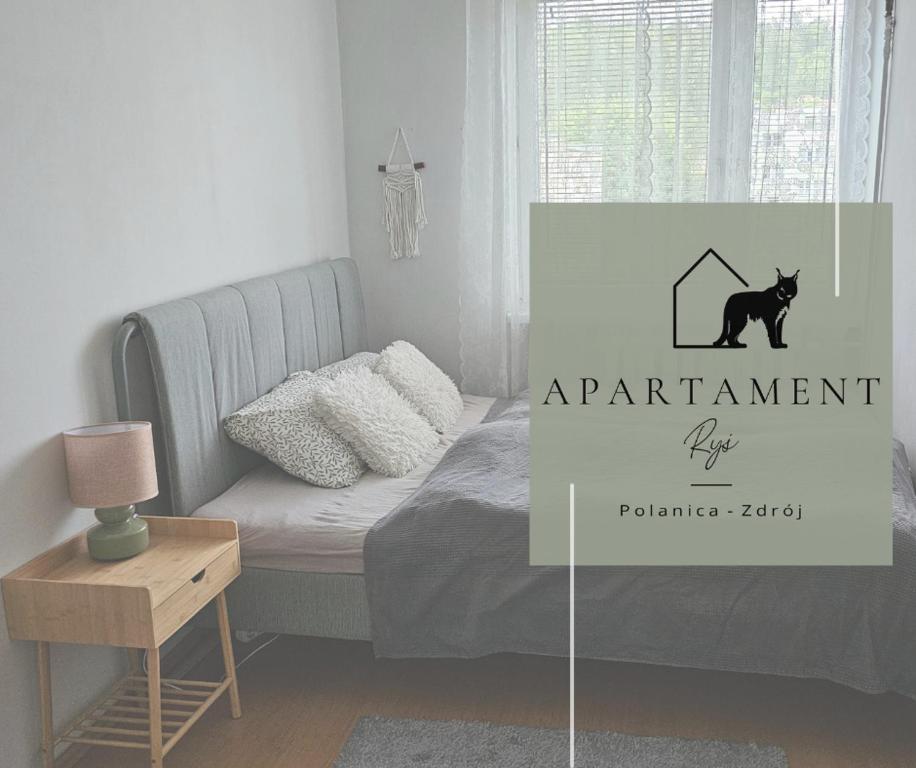 a bedroom with a bed and a sign that says apartment dyaho at Apartament RYŚ Polanica Zdrój in Polanica-Zdrój
