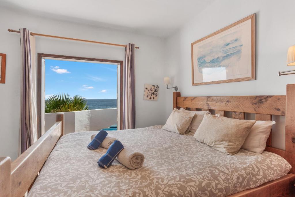 a bedroom with a bed with a view of the ocean at The Beach House Lanzarote in Tías