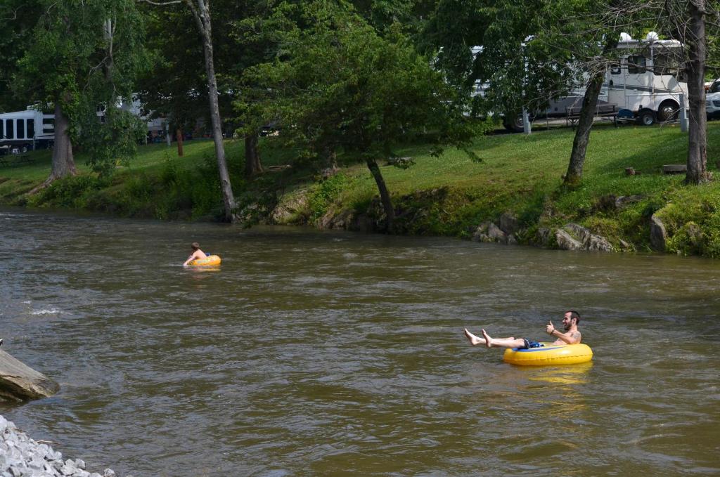 two people floating in a river in a raft at Creekstone Inn in Pigeon Forge