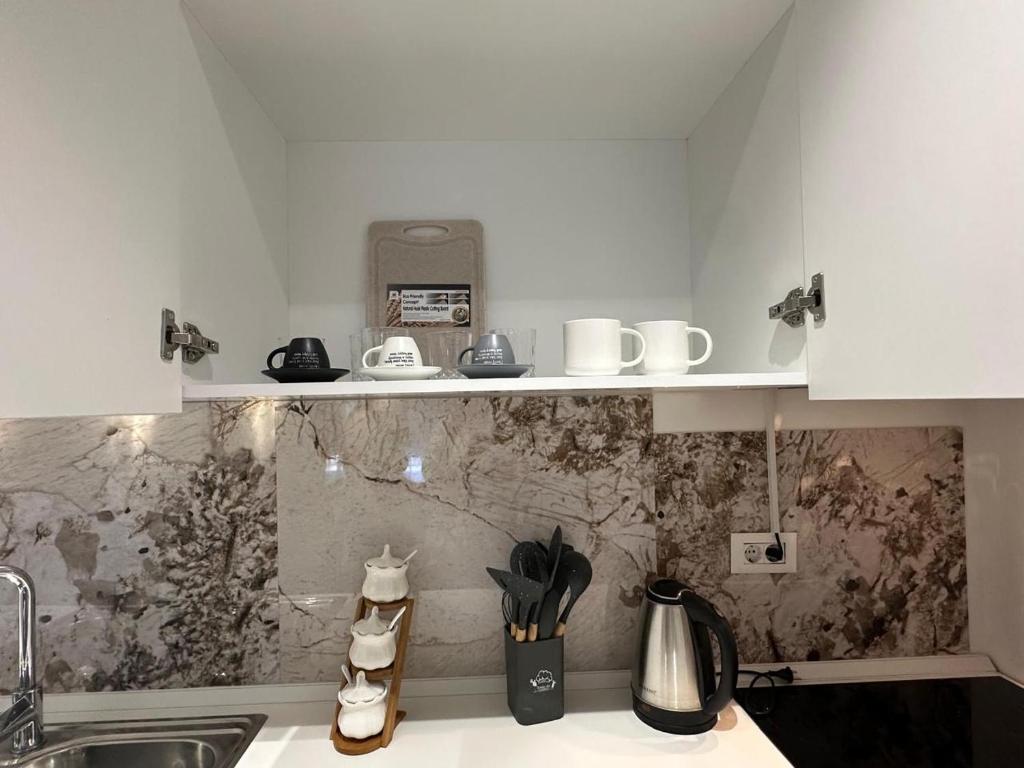 a kitchen with a sink and a counter top at Noema Apartment 5 Maji - A Cosy Stay in Tirana in Tirana