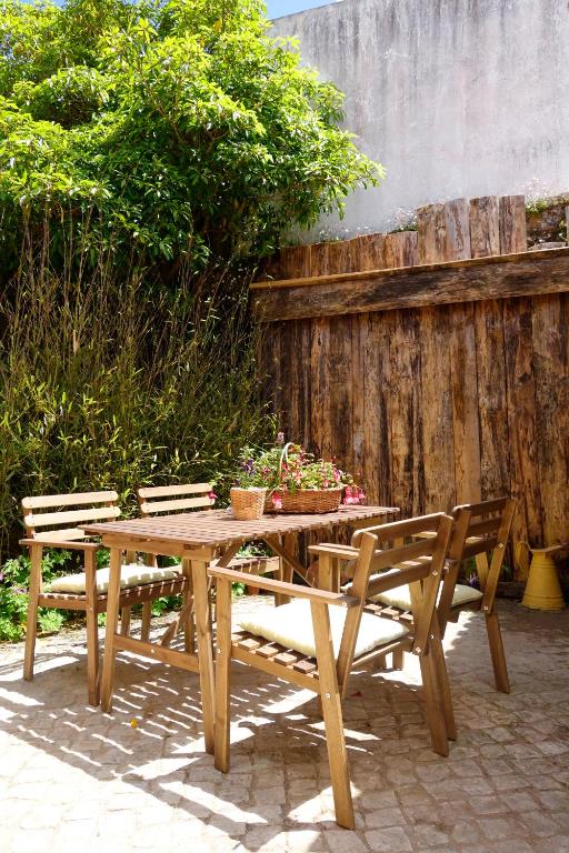 a wooden table with two chairs and a wooden fence at Sparrow Sintra Nest in Sintra