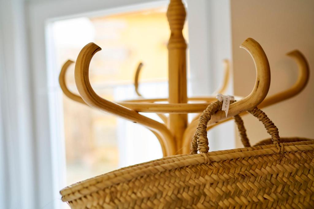 a rattan basket with a table in a window at Sparrow Sintra Nest in Sintra